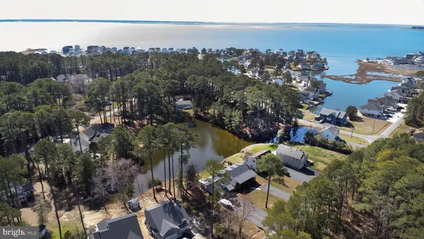 an aerial view of a house with a yard and lake view