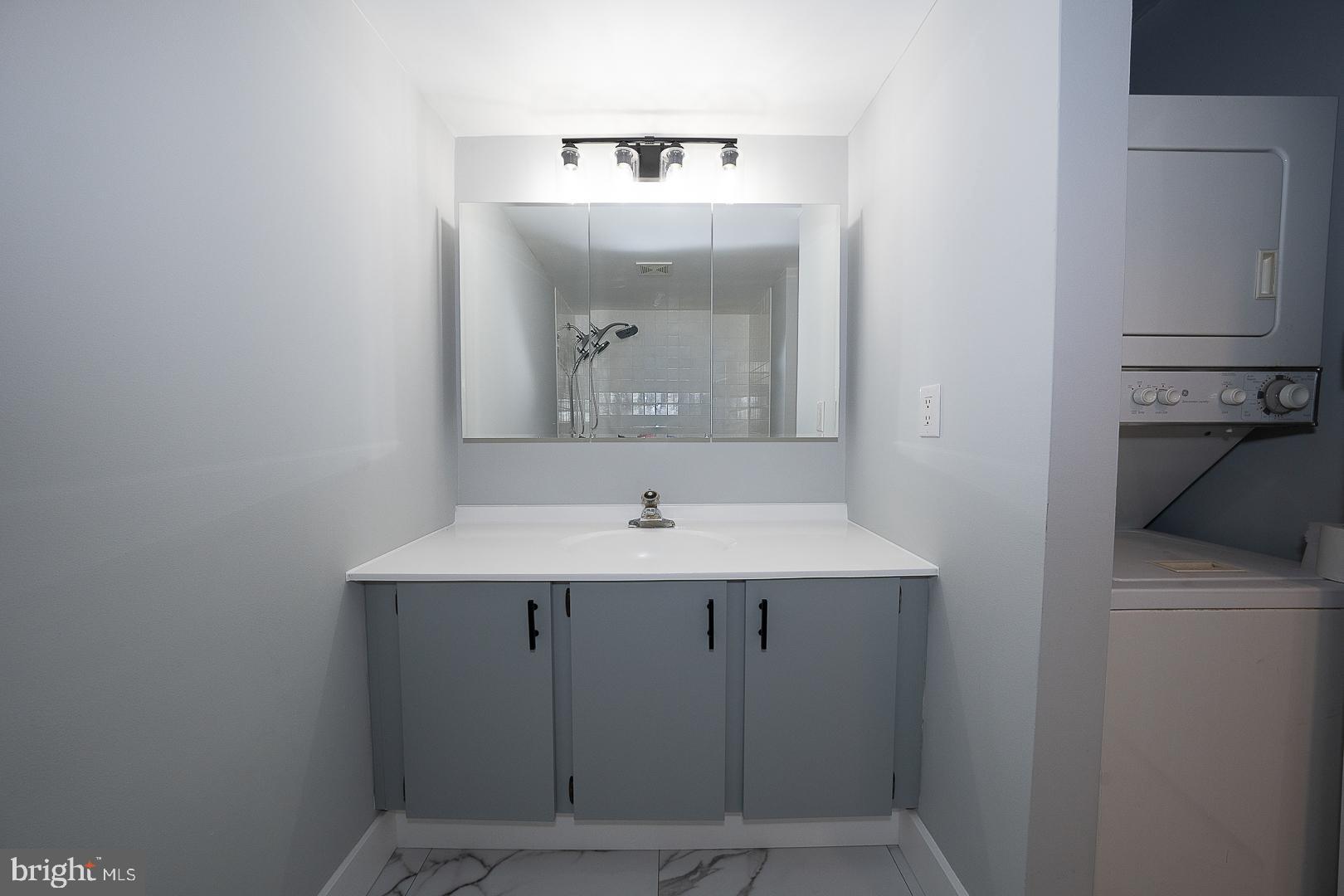 1420 Locust Street, Unit 7E Philadelphia, PA 19102 - Photo 13 of 24 a bathroom with a sink and mirror