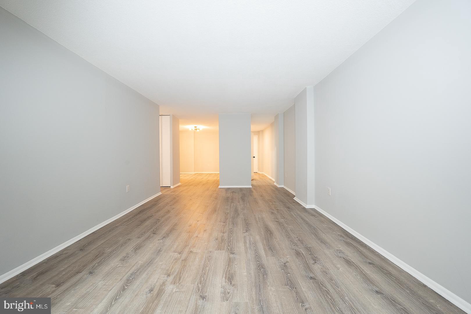 1420 Locust Street, Unit 7E Philadelphia, PA 19102 - Photo 8 of 24 a view of an empty room with wooden floor and a window