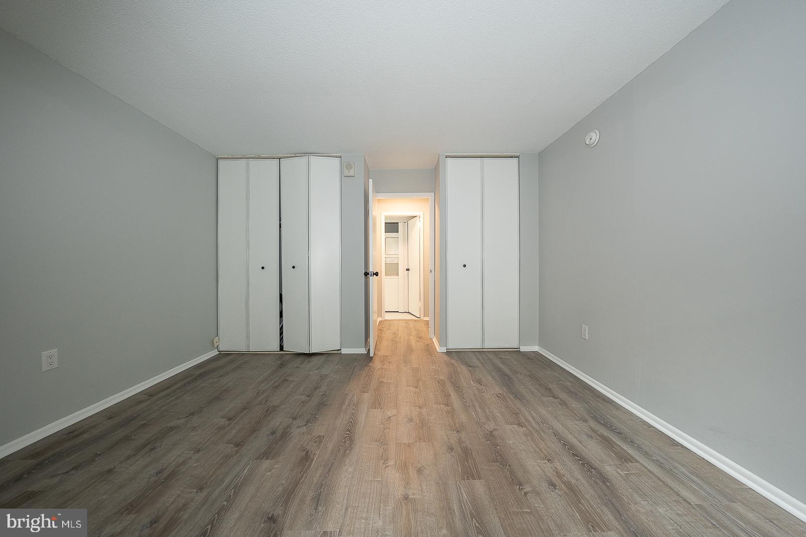 1420 Locust Street, Unit 7E Philadelphia, PA 19102 - Photo 10 of 24 a view of an empty room with wooden floor and window