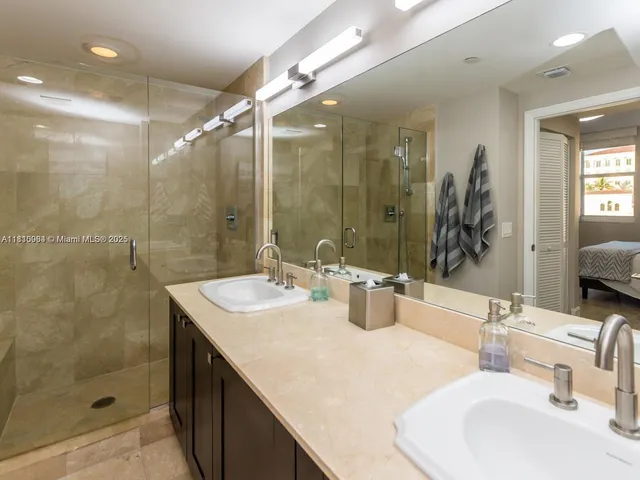 a bathroom with a sink shower and a mirror