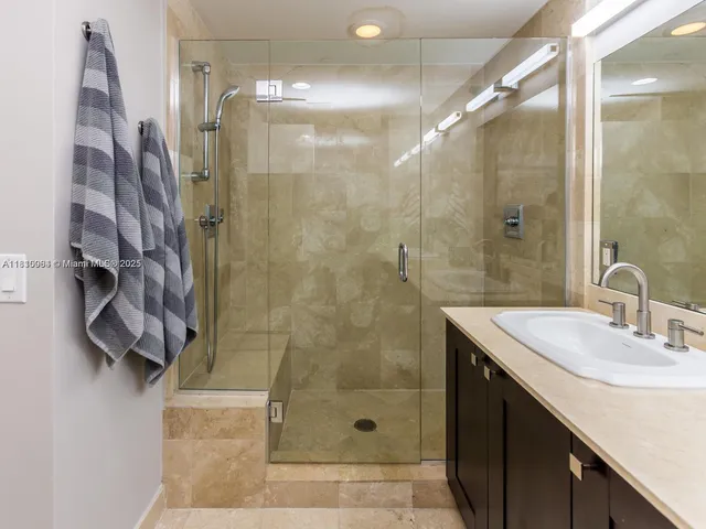 a bathroom with a shower and a sink