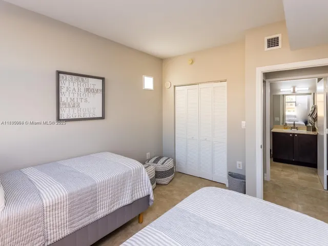 a bedroom with a bed and a view of bathroom