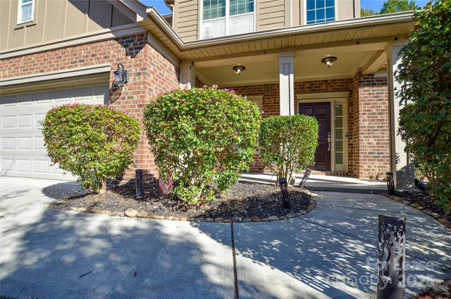 a house with potted plants in front of it