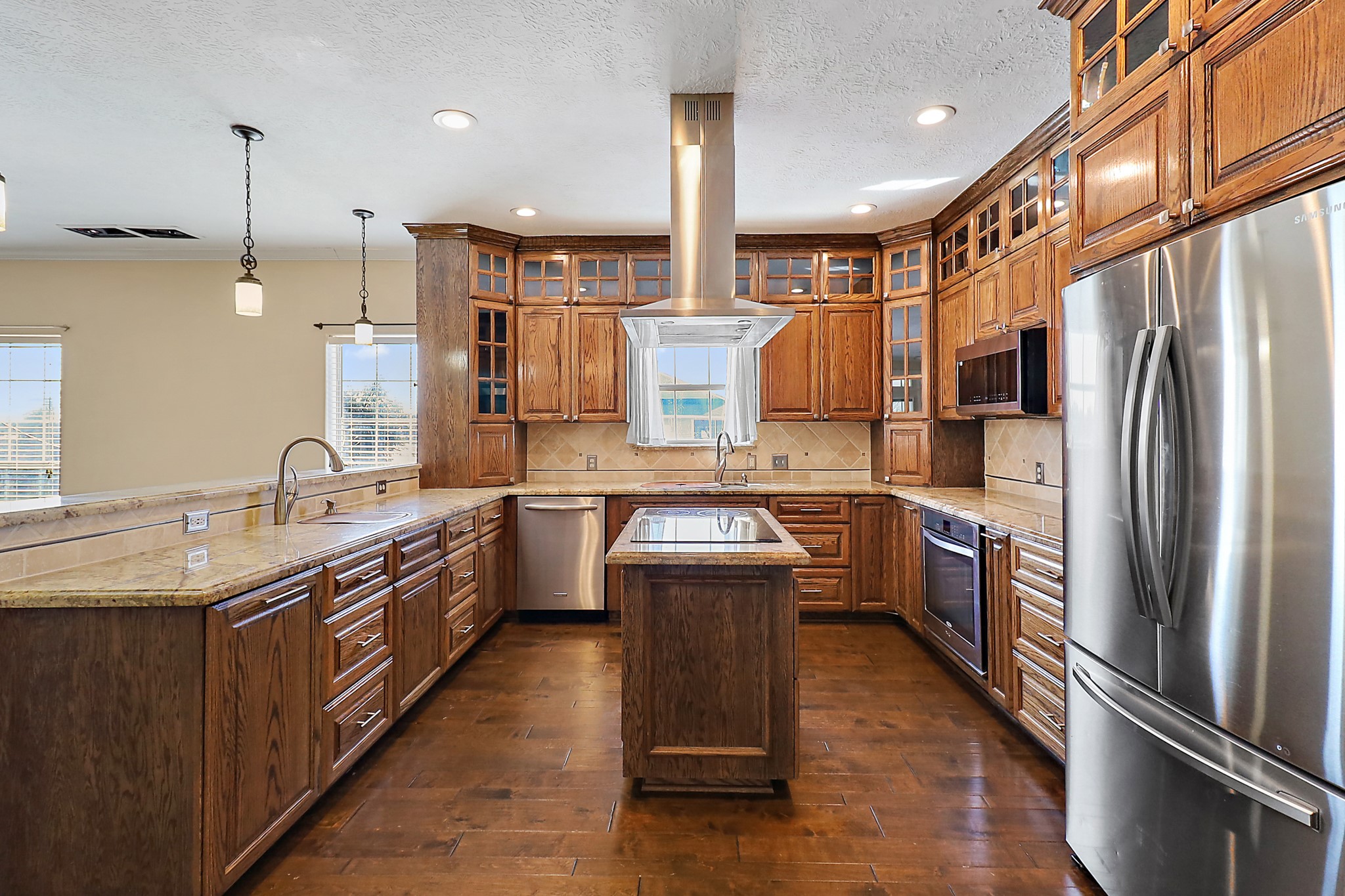1306 Spring Branch Drive Baytown, TX 77523 - Photo 27 of 38 a kitchen with stainless steel appliances granite countertop a sink a stove and a refrigerator