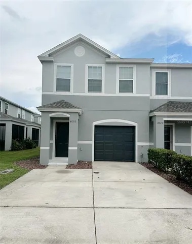 a front view of a house with garage