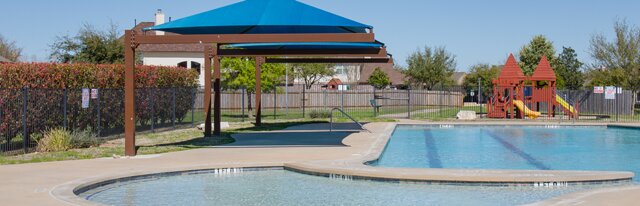 20724 Kearney Hill Road Pflugerville, TX 78660 - Photo 35 of 40 Resort-style pool area featuring a curved leisure pool, rectangular lap pool, and surrounding concrete decking