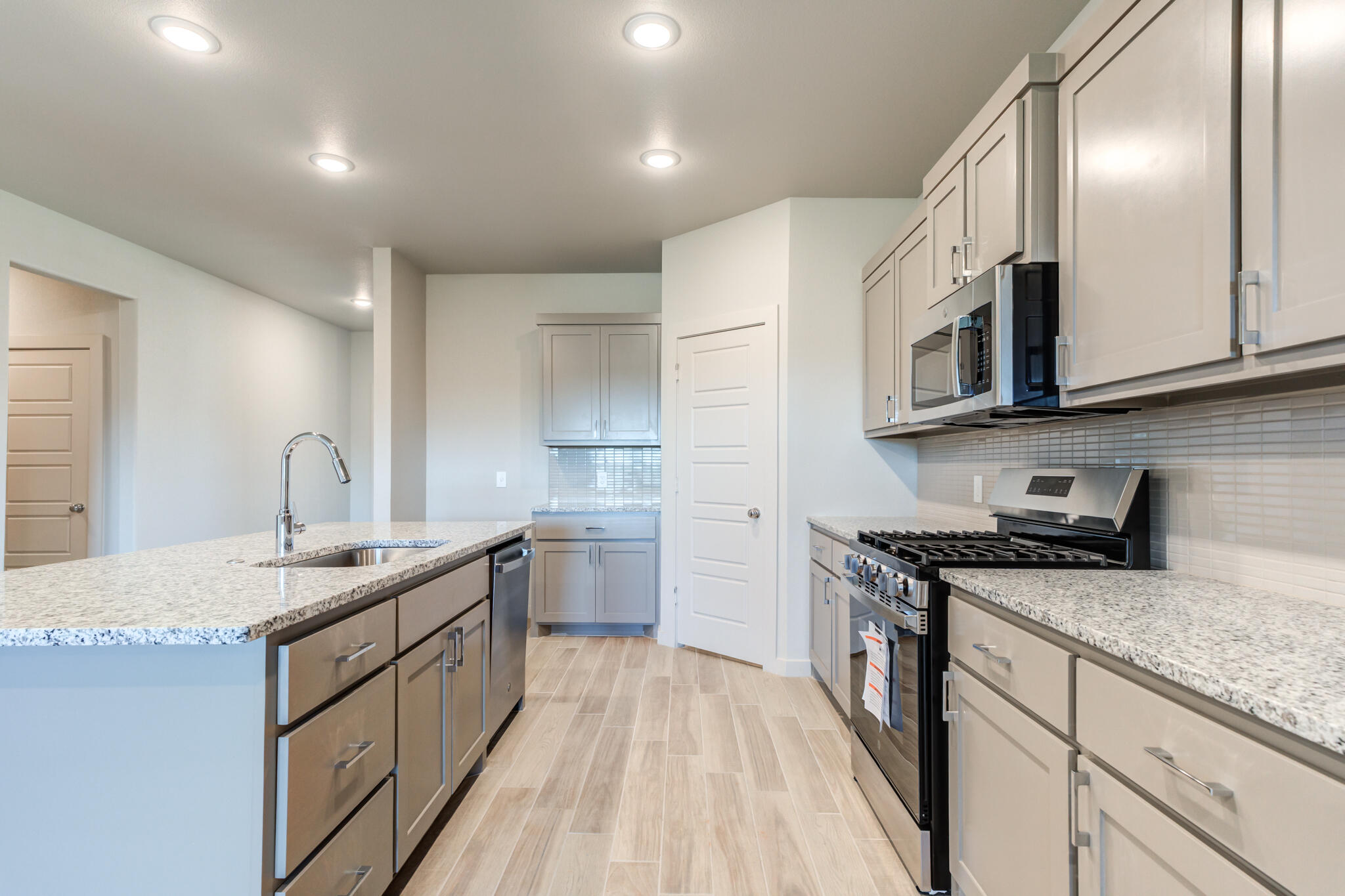 7029 25th Street Lubbock, TX 79407 - Photo 16 of 52 a kitchen with stainless steel appliances granite countertop a sink stove and cabinets