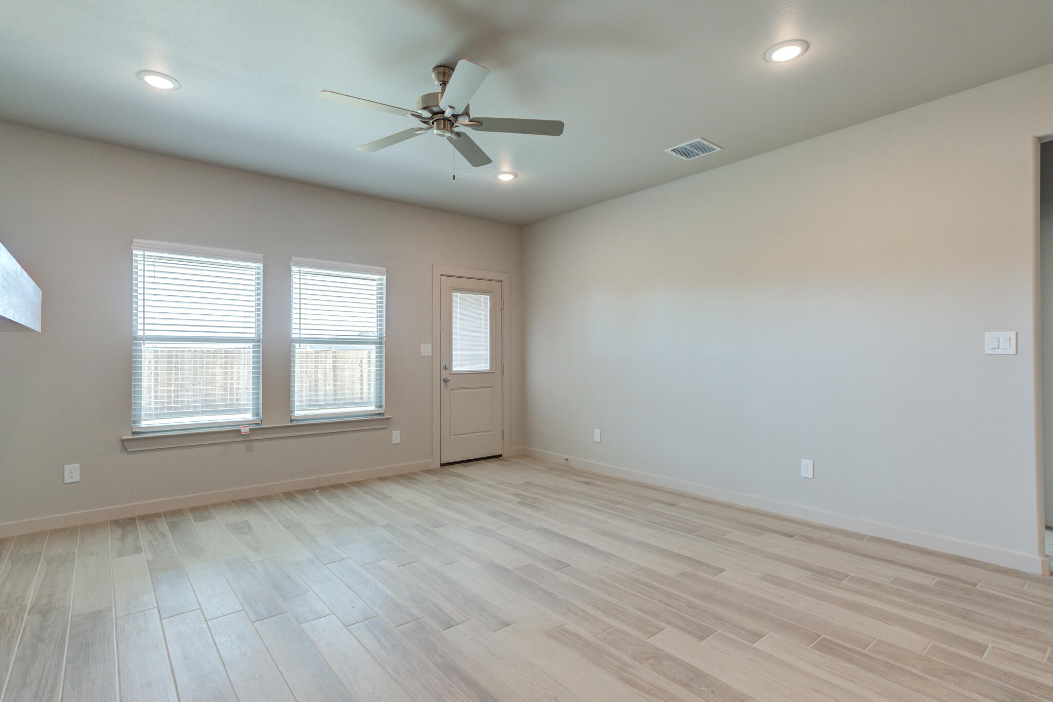 7029 25th Street Lubbock, TX 79407 - Photo 20 of 52 wooden floor in an empty room with a window