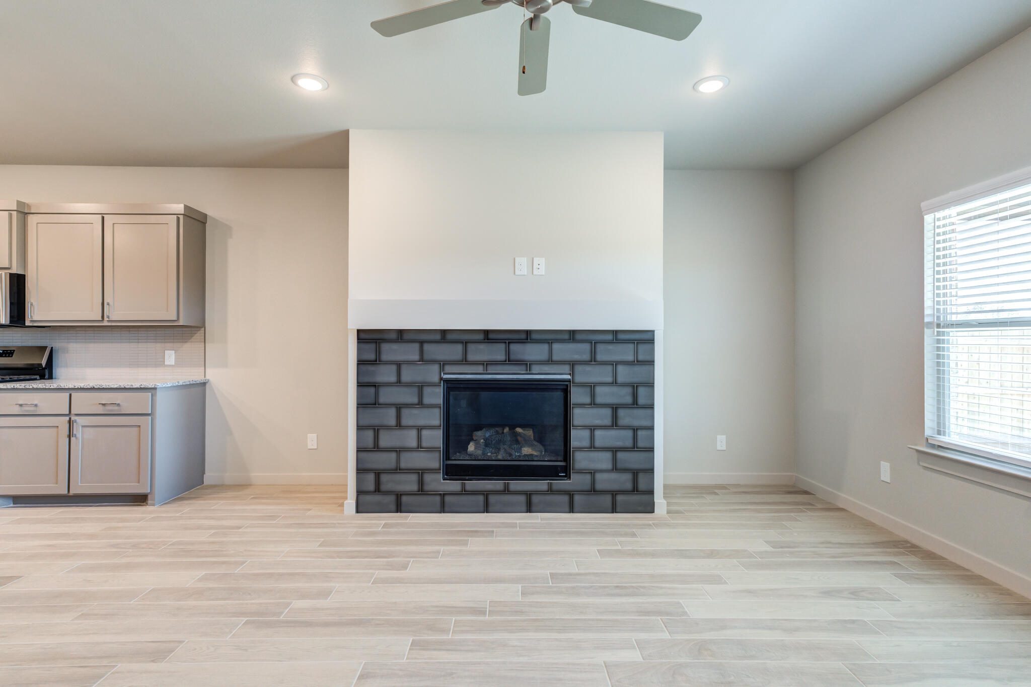 7029 25th Street Lubbock, TX 79407 - Photo 22 of 52 a living room with furniture and a fireplace