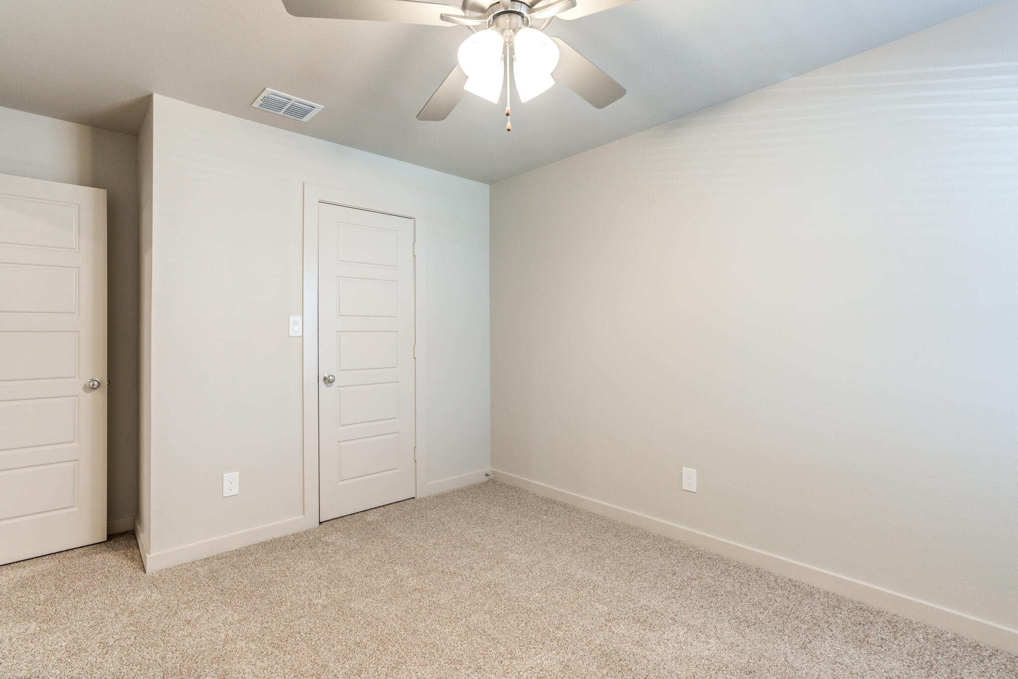 7029 25th Street Lubbock, TX 79407 - Photo 42 of 52 an empty room with a chandelier fan and closet area
