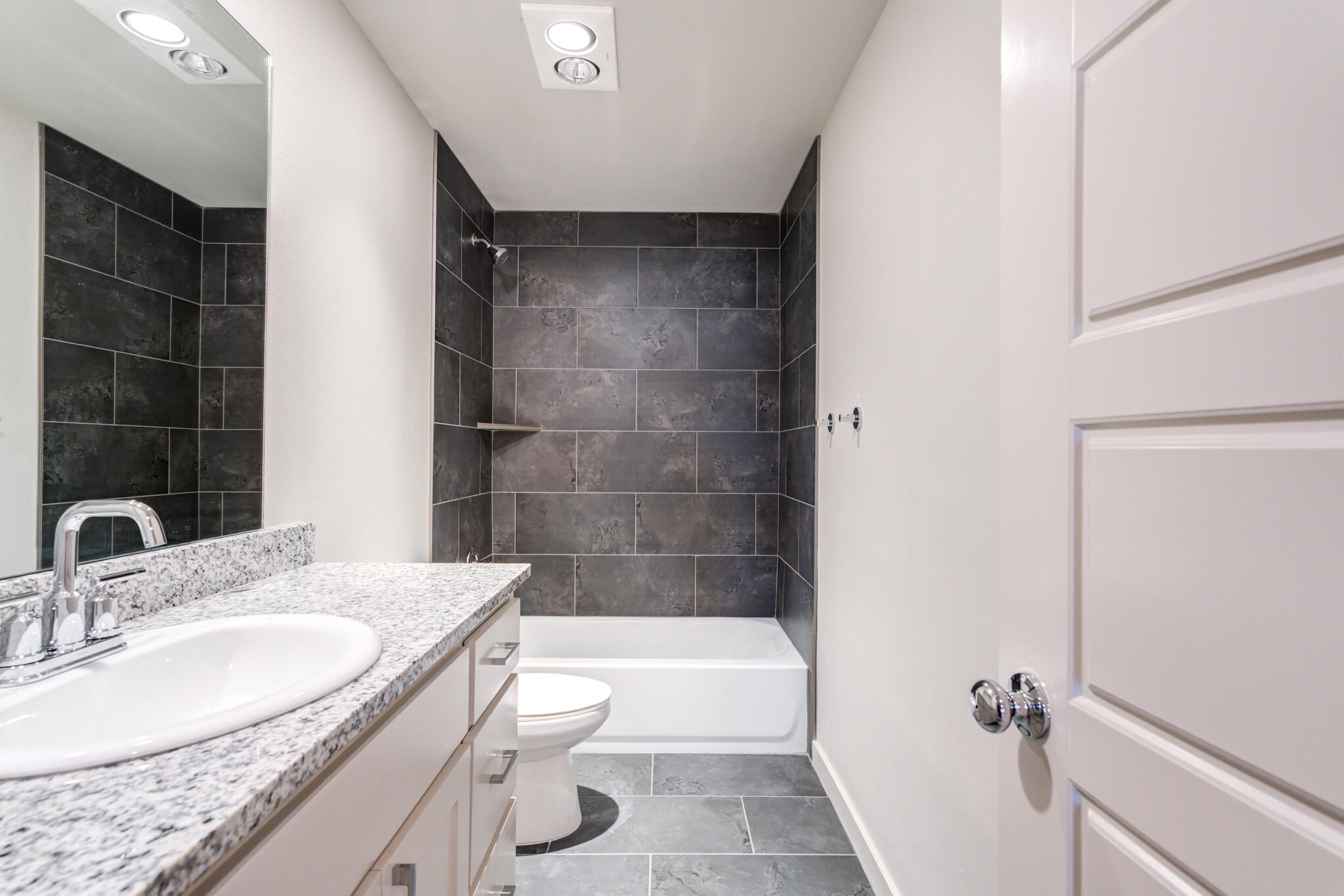 7029 25th Street Lubbock, TX 79407 - Photo 44 of 52 a bathroom with a granite countertop sink a toilet and shower