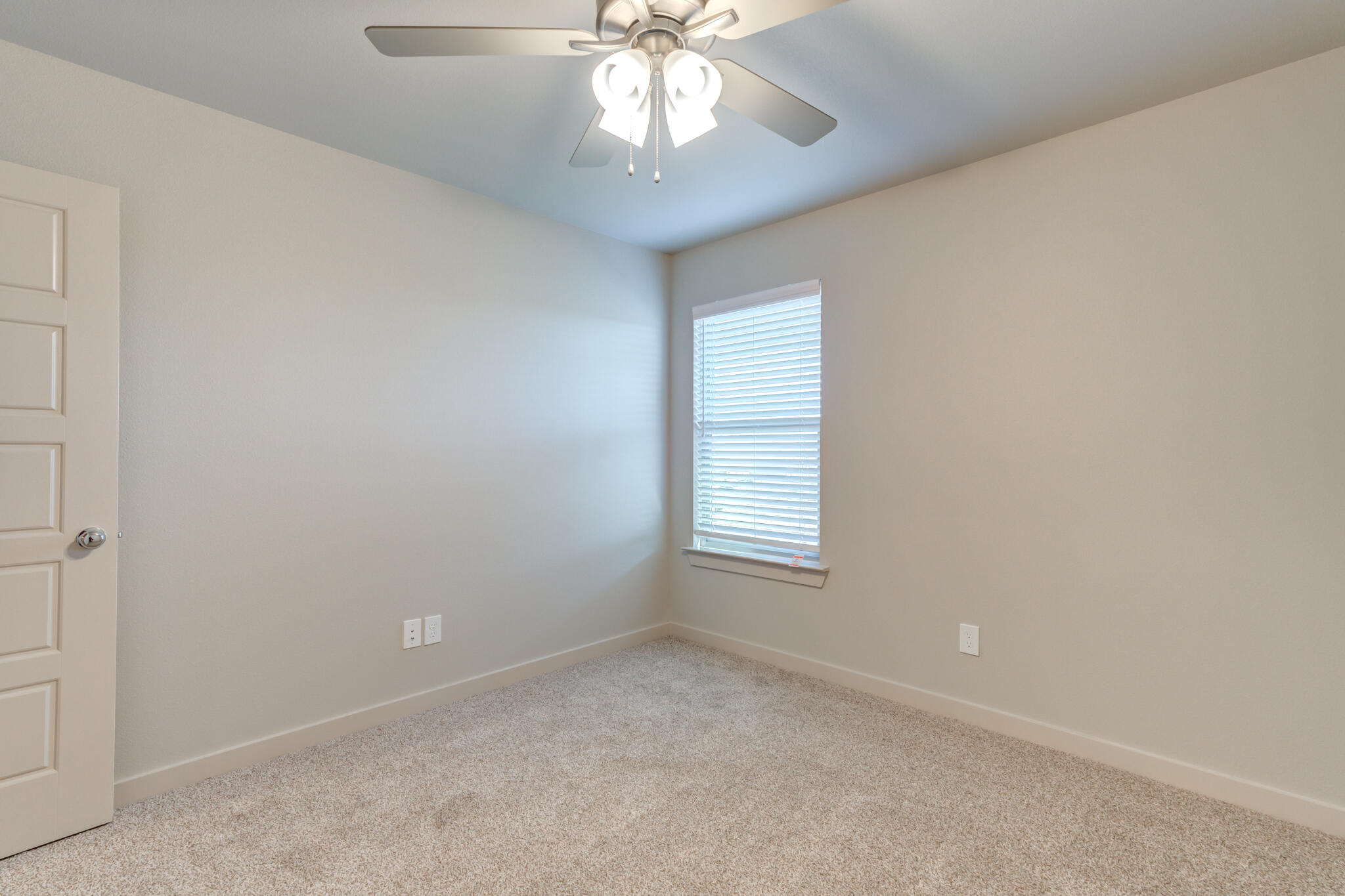 7029 25th Street Lubbock, TX 79407 - Photo 46 of 52 an empty room with a chandelier fan and windows
