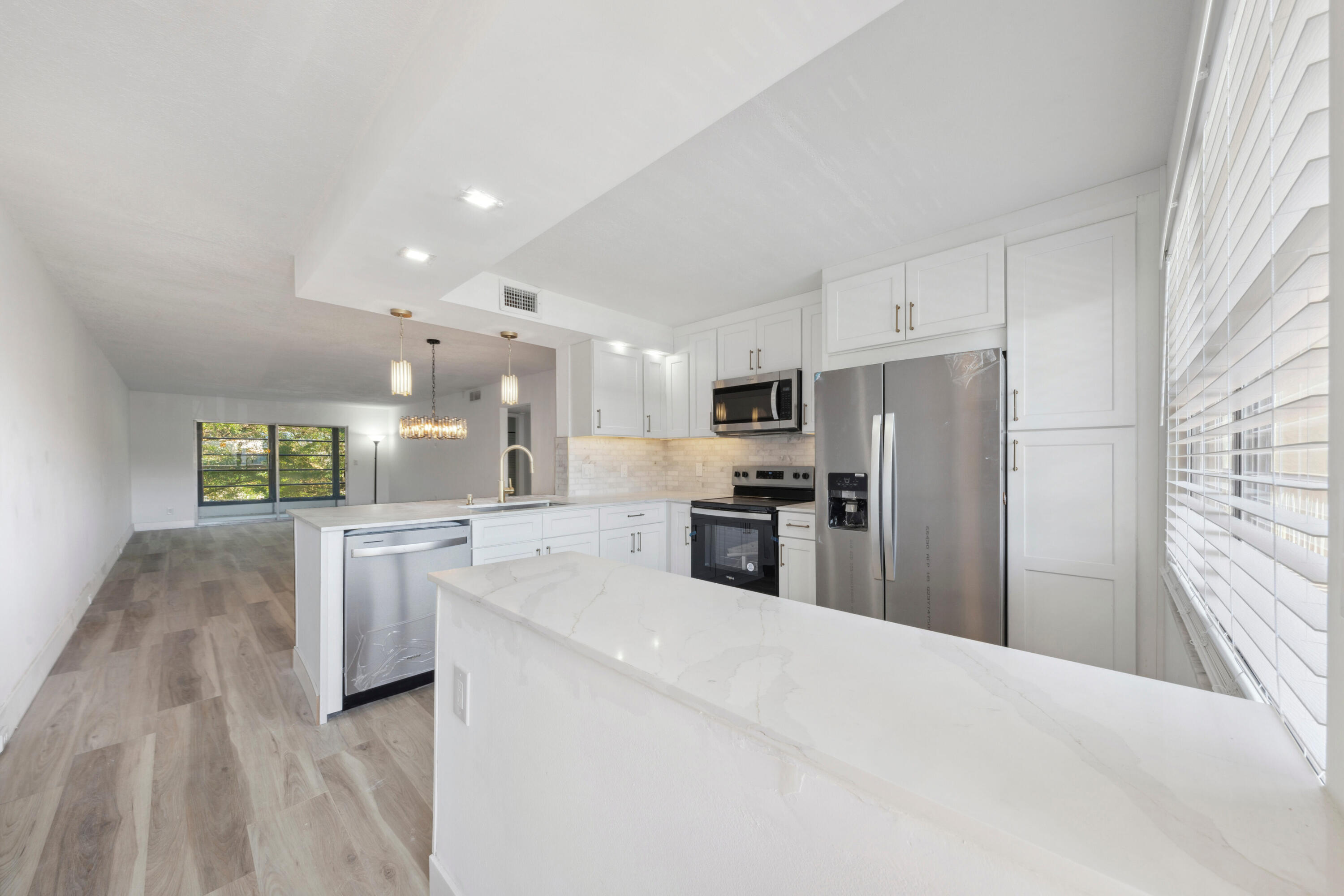 3201 Portofino Point, Unit D3 Coconut Creek, FL 33066 - Photo 1 of 34 a kitchen with stainless steel appliances kitchen island granite countertop a refrigerator sink and stove