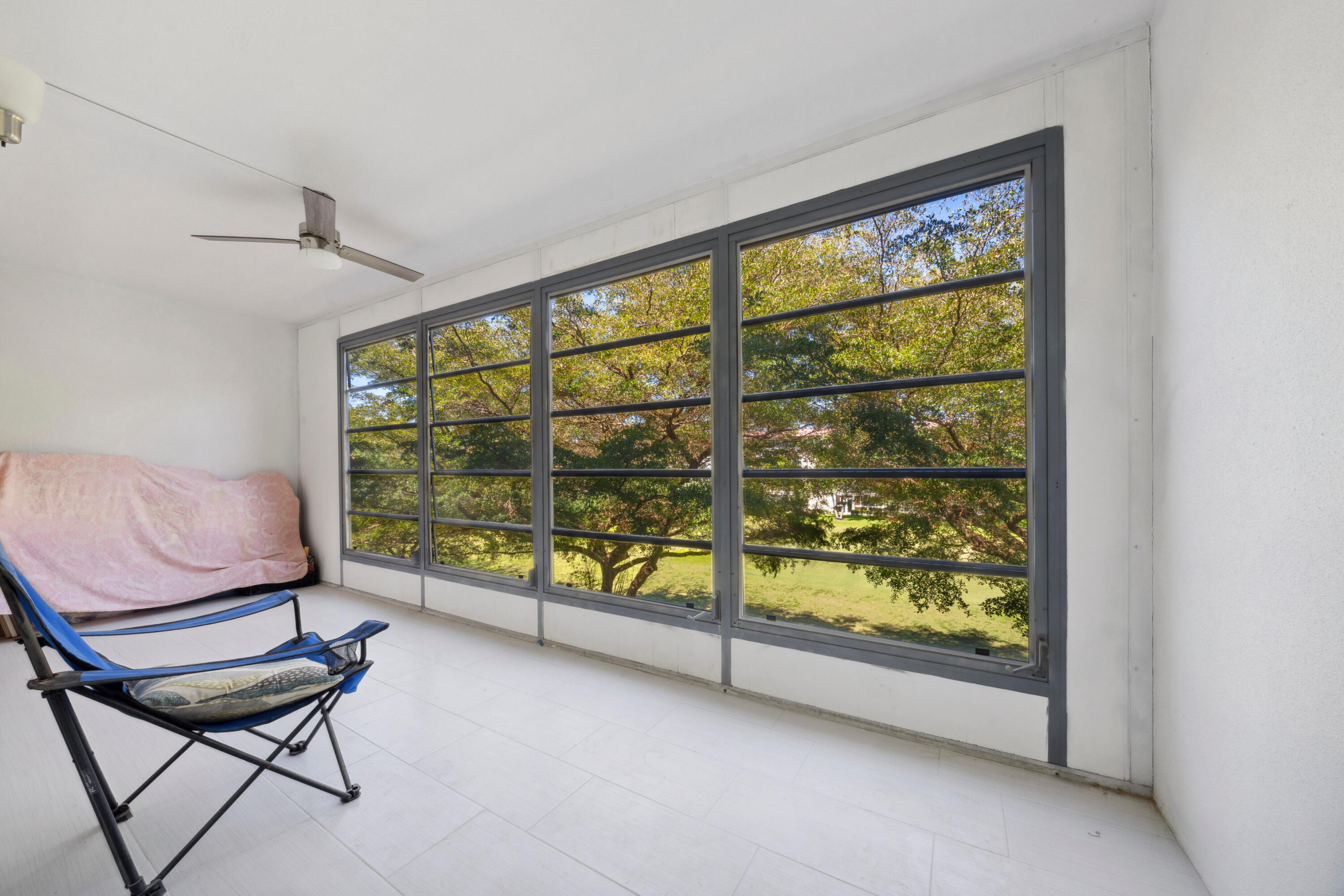 3201 Portofino Point, Unit D3 Coconut Creek, FL 33066 - Photo 13 of 34 a living room with furniture and a large window