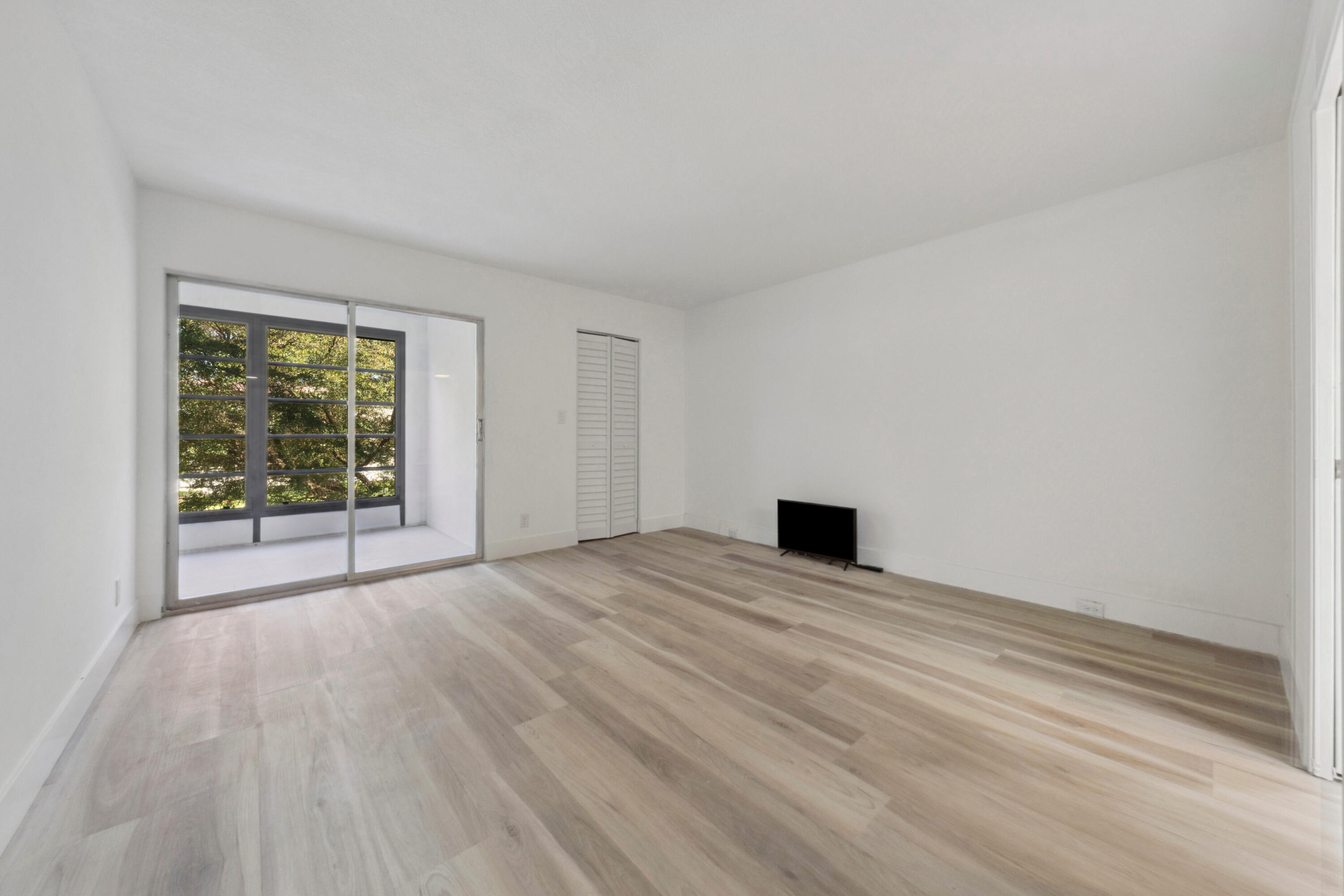 3201 Portofino Point, Unit D3 Coconut Creek, FL 33066 - Photo 16 of 34 a view of empty room with wooden floor and fan