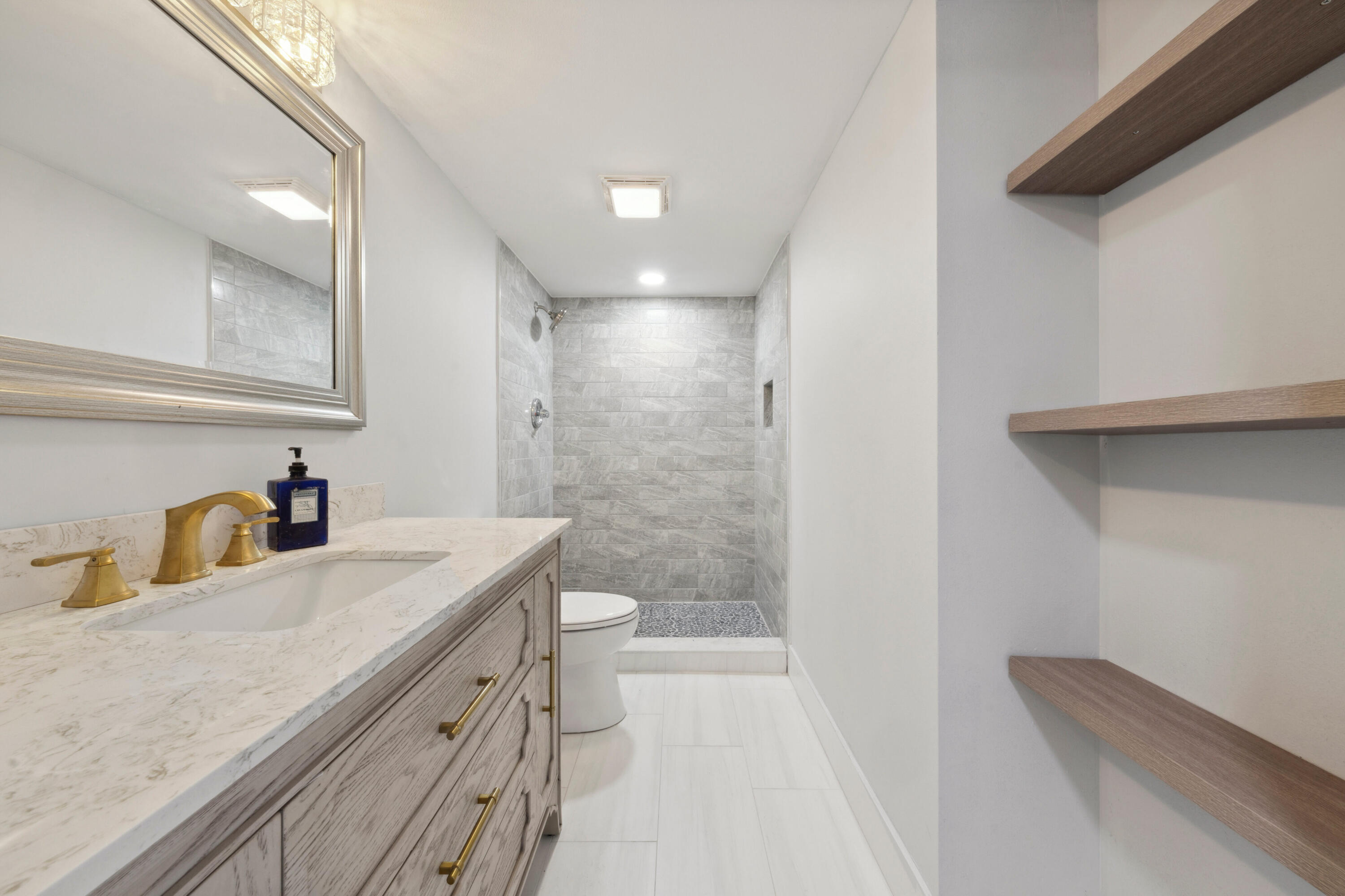 3201 Portofino Point, Unit D3 Coconut Creek, FL 33066 - Photo 20 of 34 a bathroom with a sink a toilet and shower