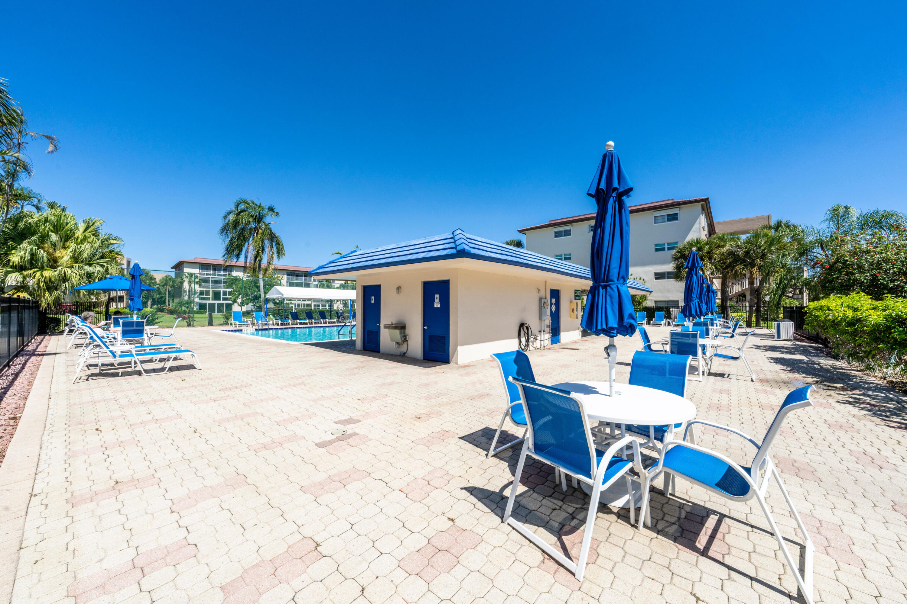 3201 Portofino Point, Unit D3 Coconut Creek, FL 33066 - Photo 24 of 34 a view of a patio with table and chairs potted plants
