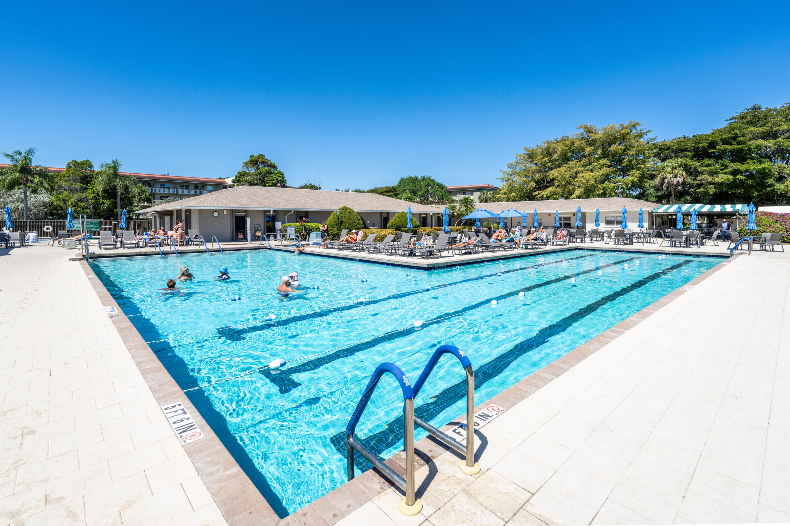 3201 Portofino Point, Unit D3 Coconut Creek, FL 33066 - Photo 27 of 34 a view of a swimming pool with a chairs