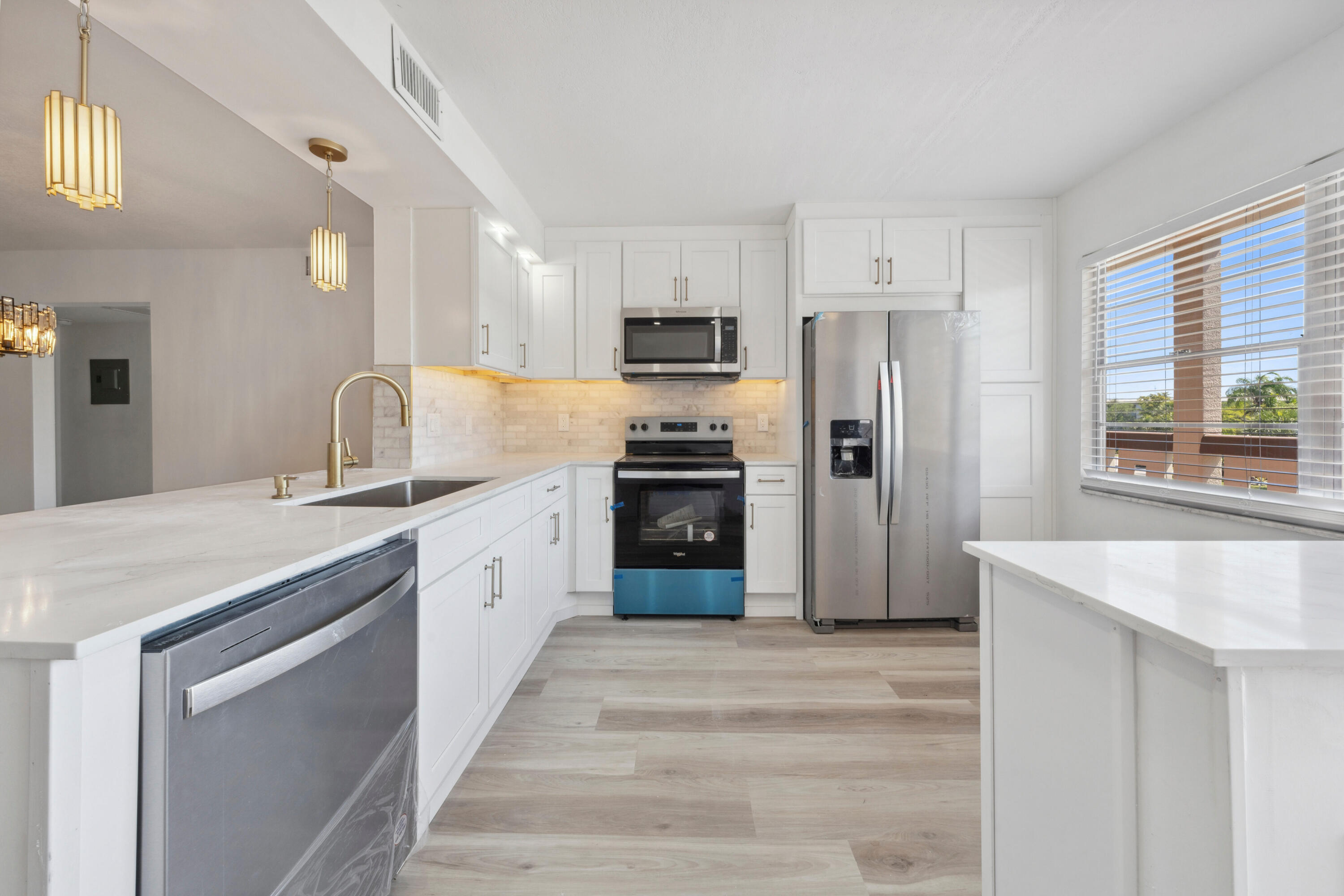 3201 Portofino Point, Unit D3 Coconut Creek, FL 33066 - Photo 6 of 34 a kitchen with granite countertop a refrigerator and a sink