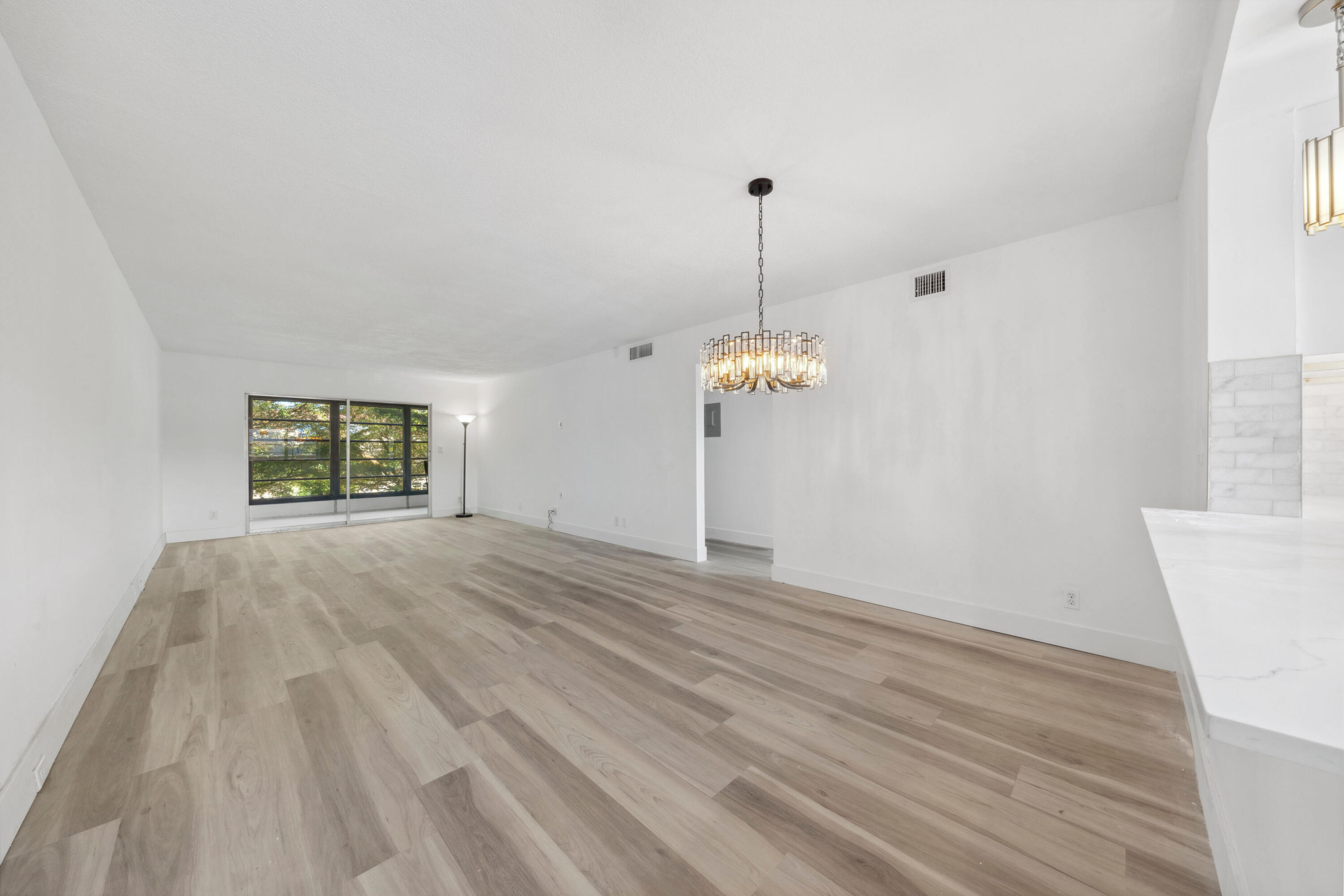 3201 Portofino Point, Unit D3 Coconut Creek, FL 33066 - Photo 7 of 34 a view of empty room with wooden floor