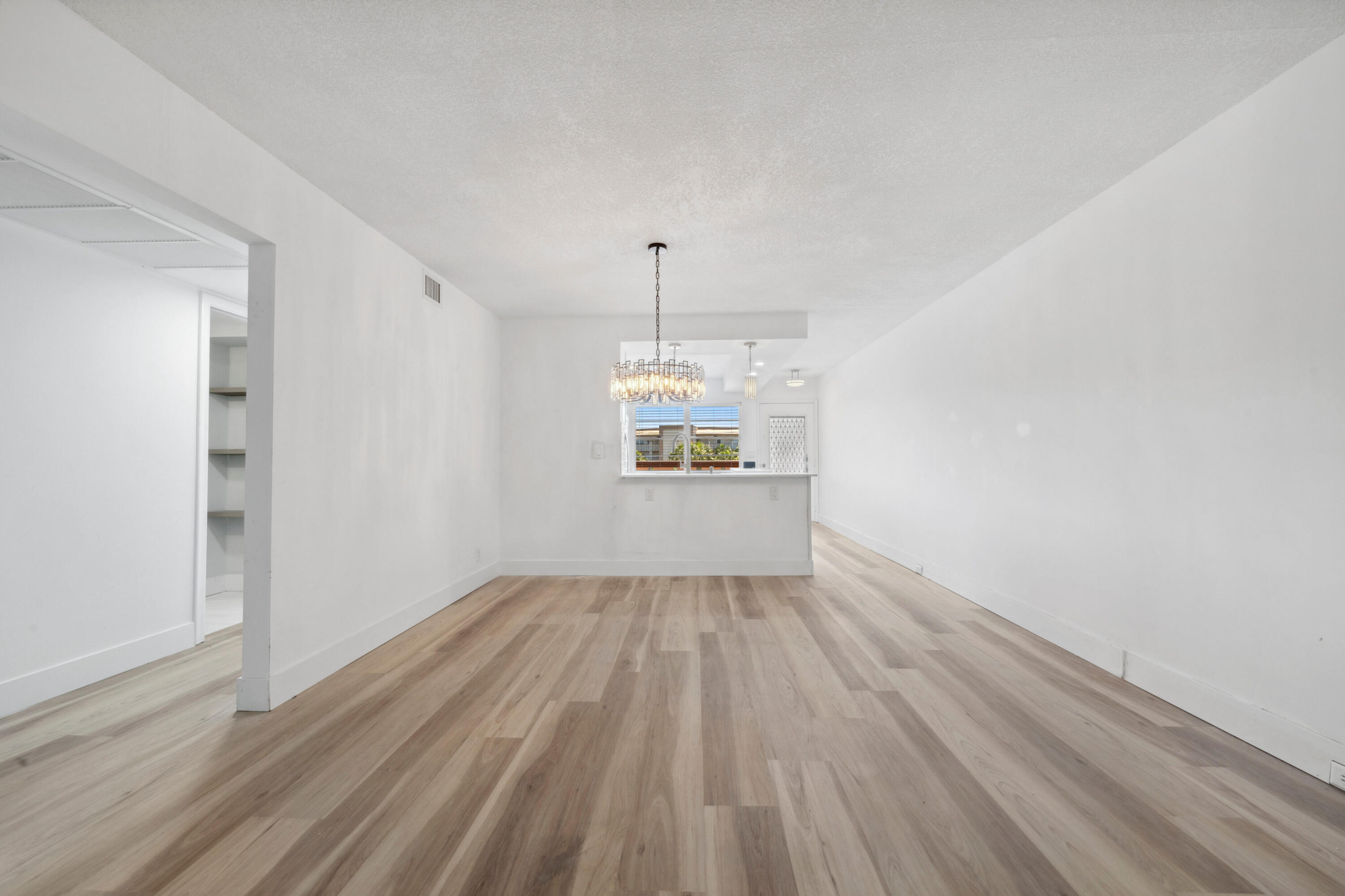 3201 Portofino Point, Unit D3 Coconut Creek, FL 33066 - Photo 8 of 34 wooden floor in an empty room with a window