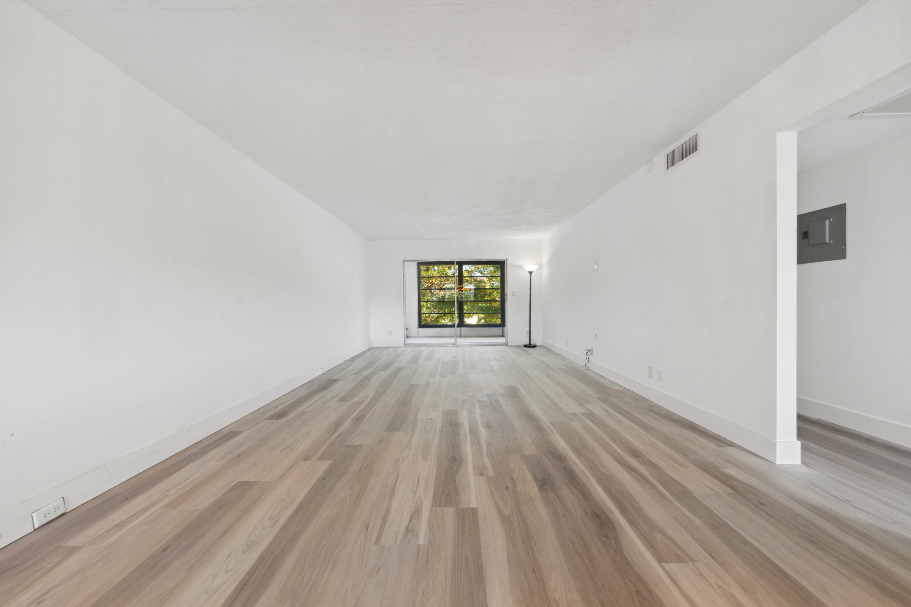 3201 Portofino Point, Unit D3 Coconut Creek, FL 33066 - Photo 9 of 34 wooden floor in an empty room with a window