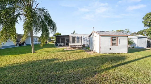 a swimming pool with yard and outdoor seating