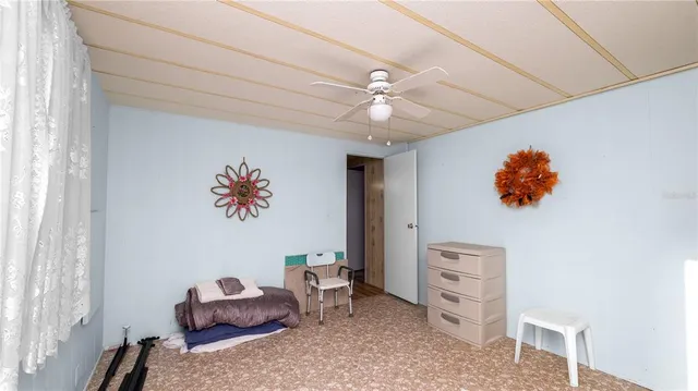 a bedroom with furniture and a window