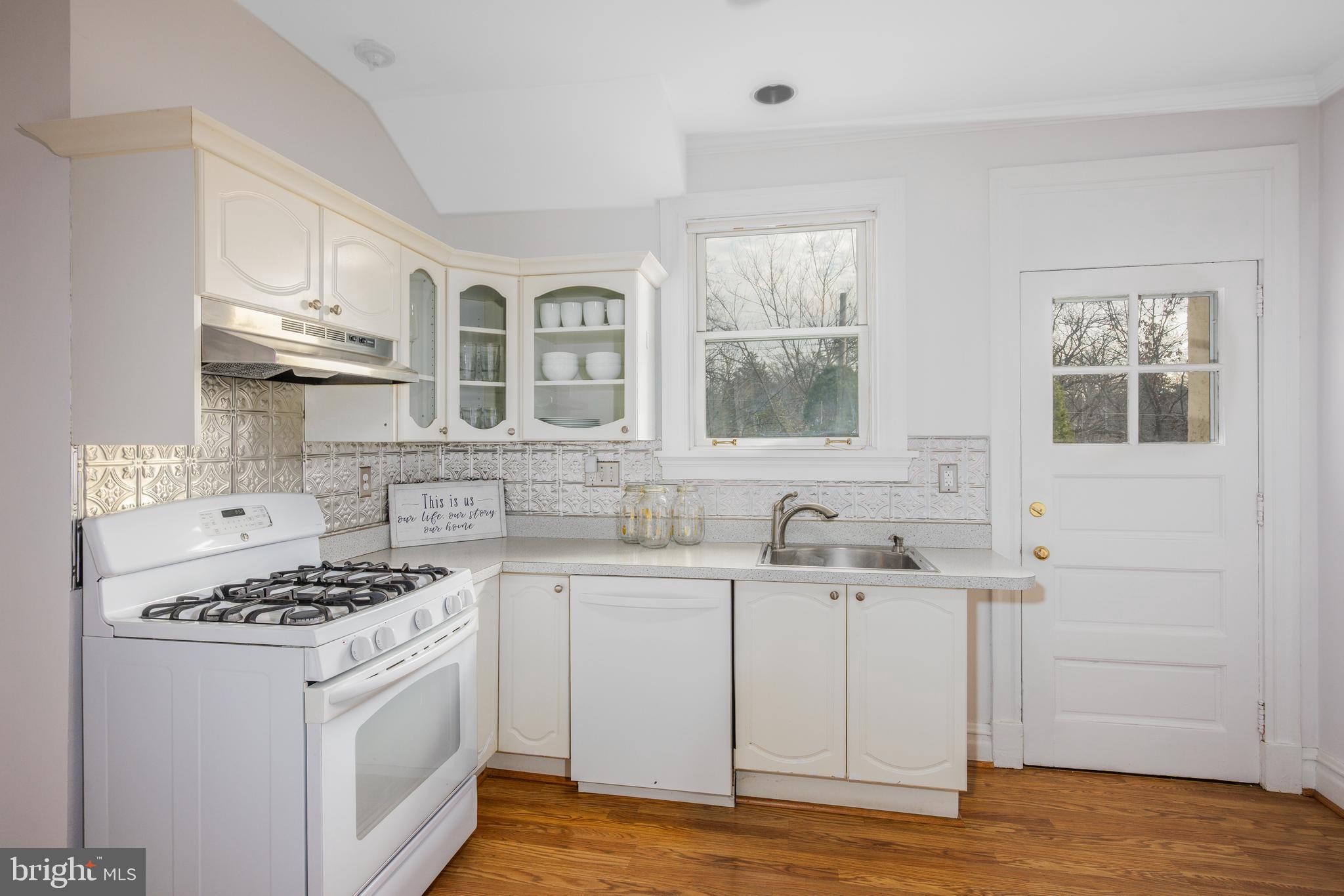 4307 Wickford Road Baltimore, MD 21210 - Photo 11 of 38 a kitchen with stainless steel appliances a sink stove and cabinets