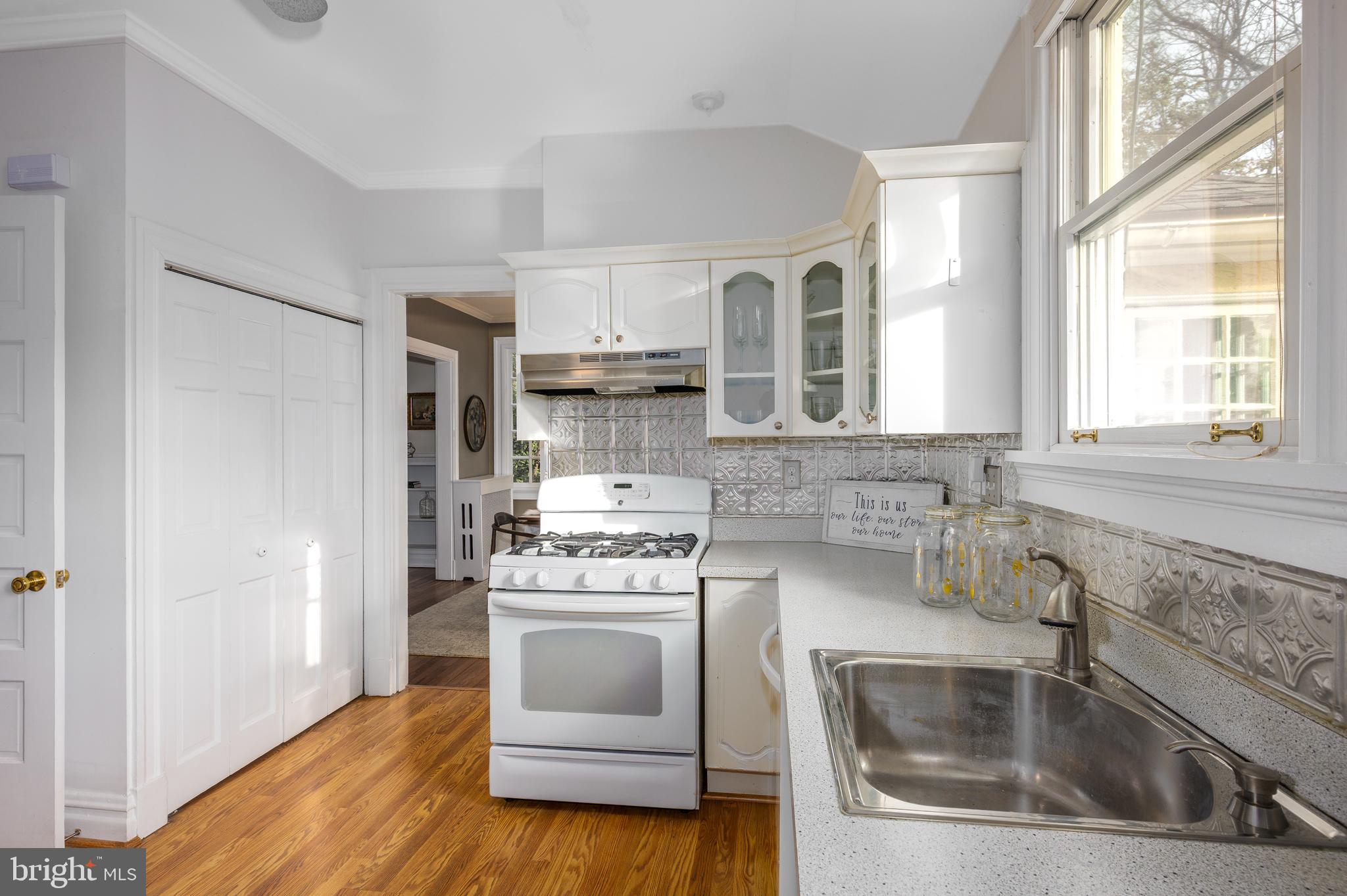 4307 Wickford Road Baltimore, MD 21210 - Photo 12 of 38 a kitchen with white cabinets and white appliances