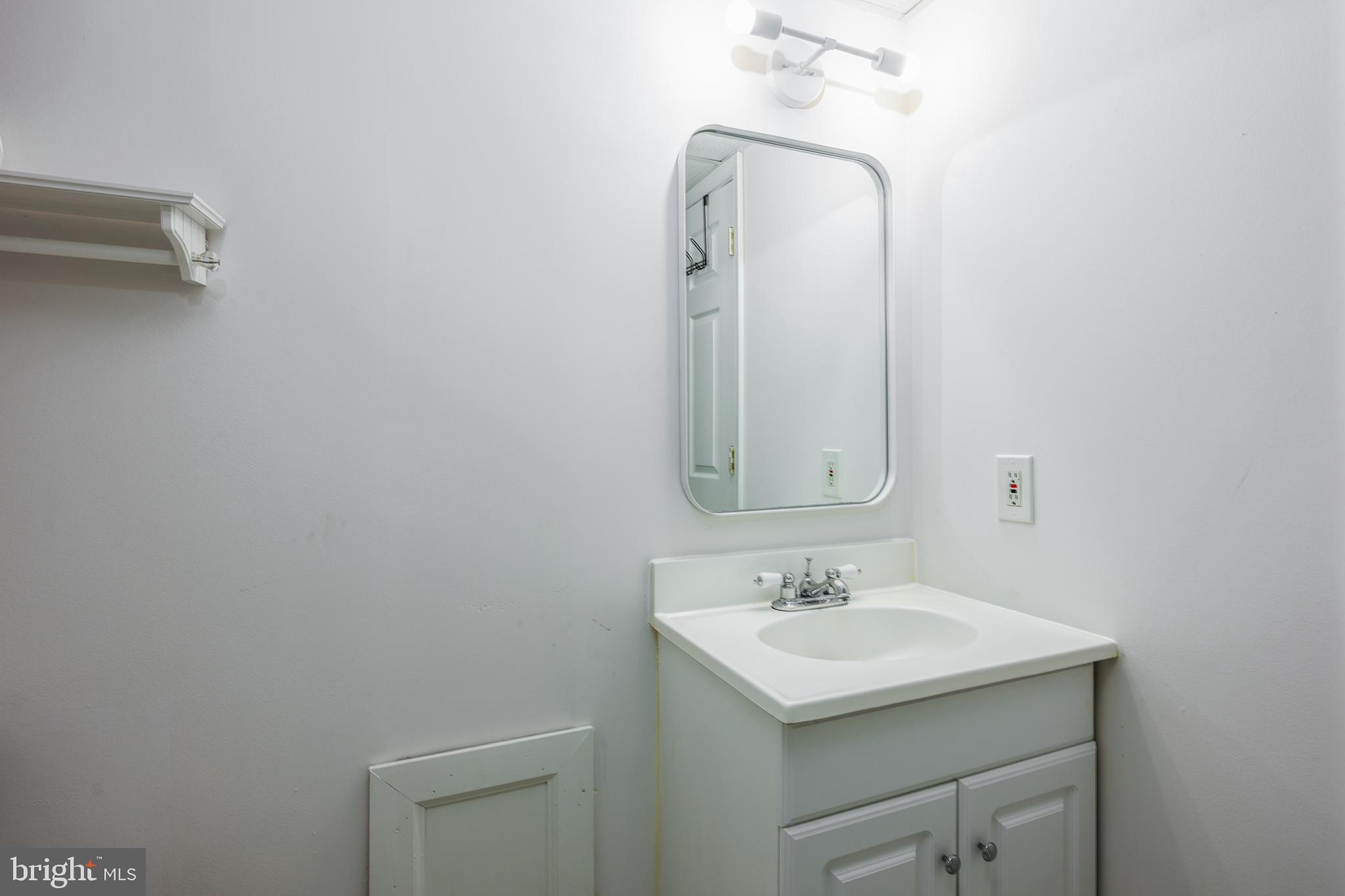 4307 Wickford Road Baltimore, MD 21210 - Photo 32 of 38 a bathroom with a sink and a mirror