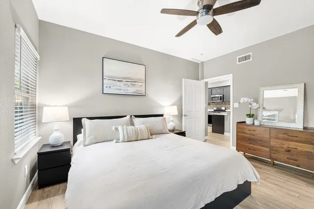 a bedroom with a bed and a chandelier