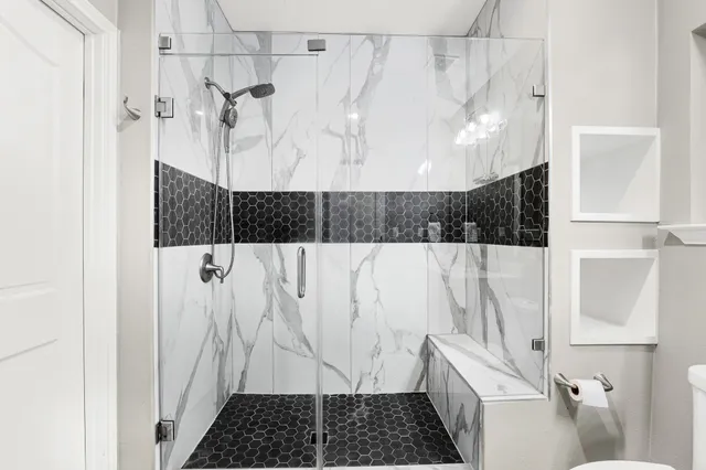 a bathroom with a shower and a sink