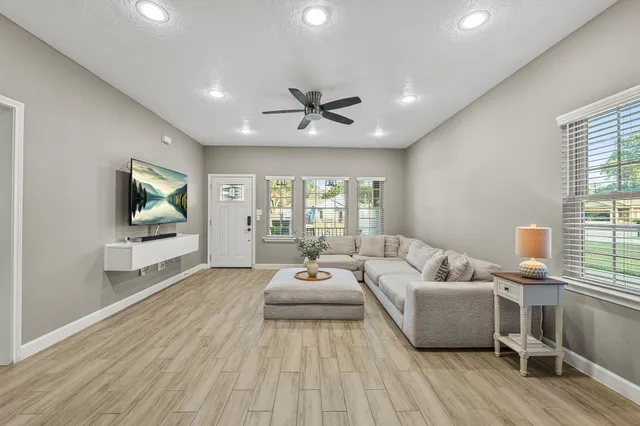 a living room with furniture and a flat screen tv