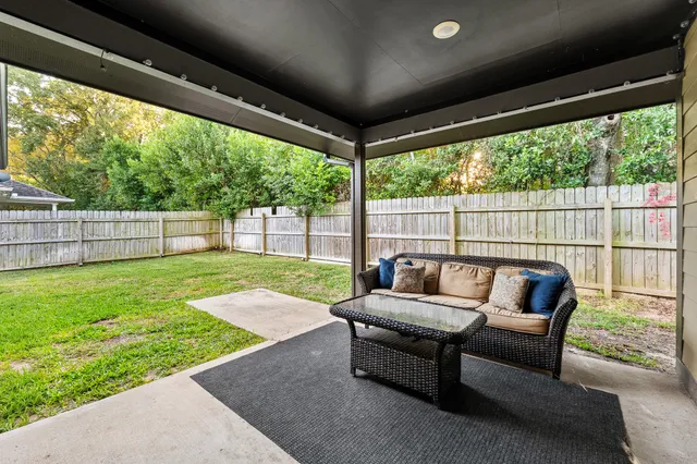 a balcony with furniture and a yard
