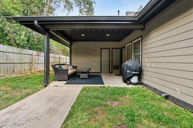 a view of a porch with furniture and backyard