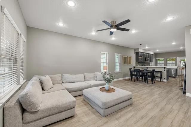 a living room with furniture and kitchen view