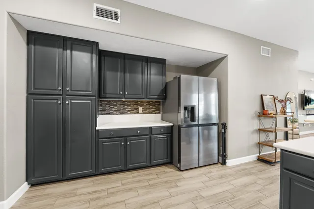 a kitchen with stainless steel appliances granite countertop a refrigerator and a sink