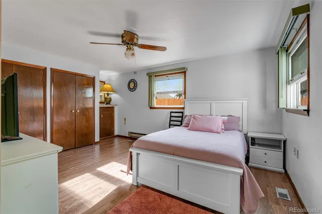 a bedroom with a bed and a refrigerator