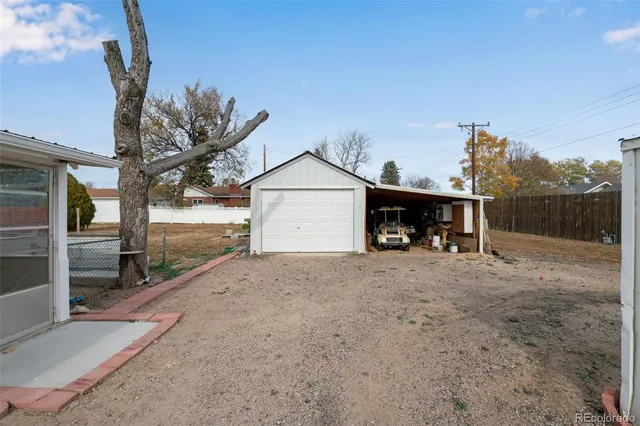 a view of a house with a yard and garage