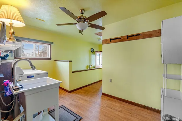 a view of a workspace with wooden floor