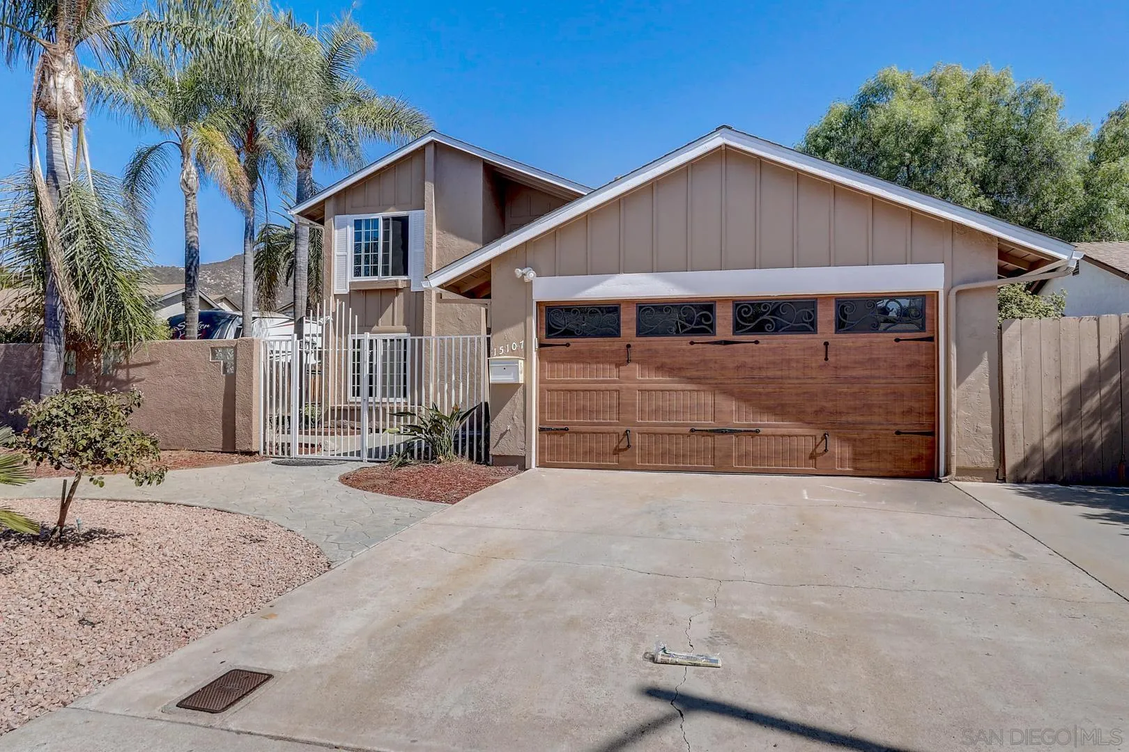 15107 Hesta Street Poway, CA 92064 - Photo 11 of 23 a front view of a house with a yard and garage