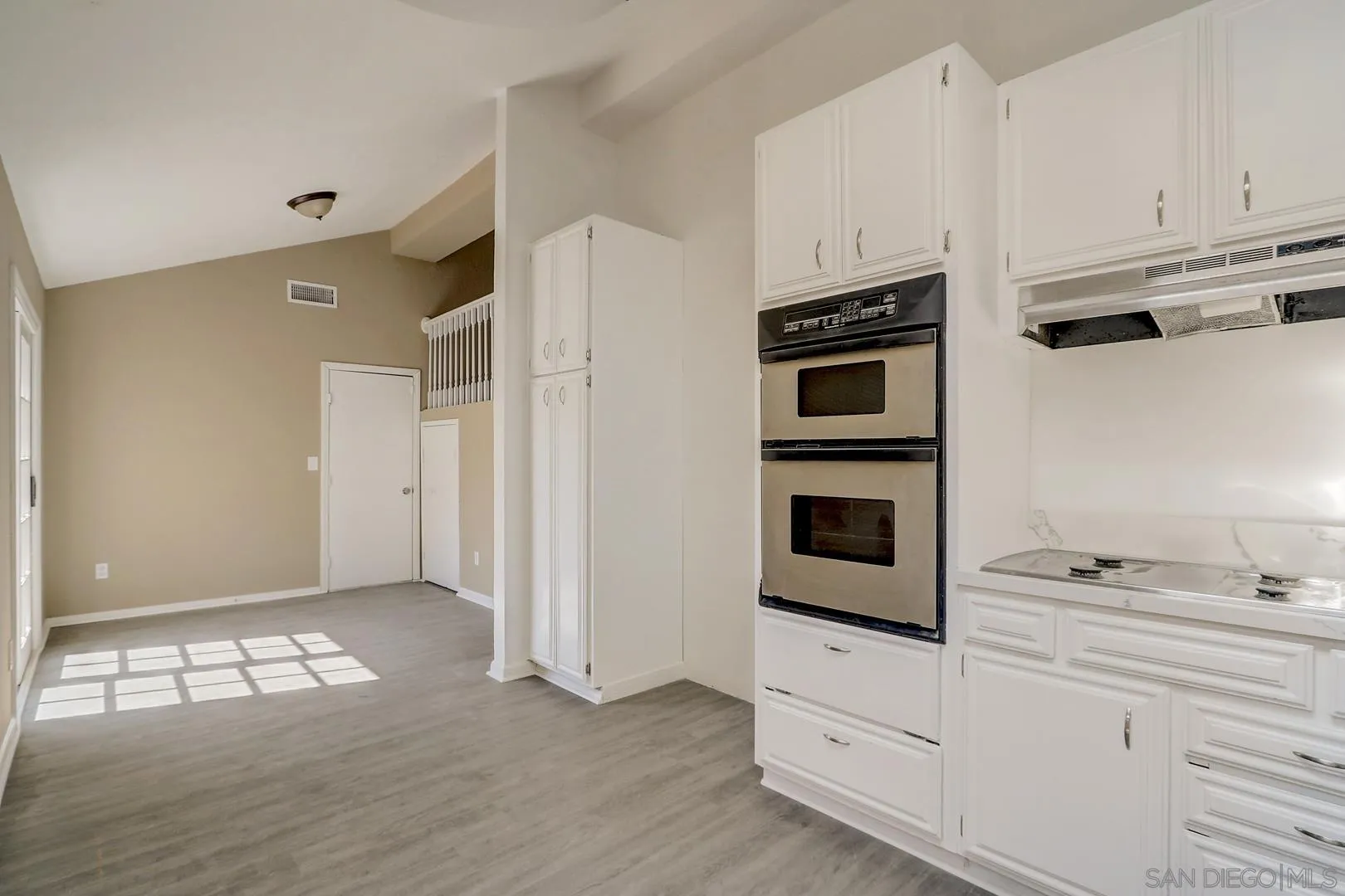 15107 Hesta Street Poway, CA 92064 - Photo 17 of 23 a kitchen with granite countertop white cabinets and steel stainless steel appliances