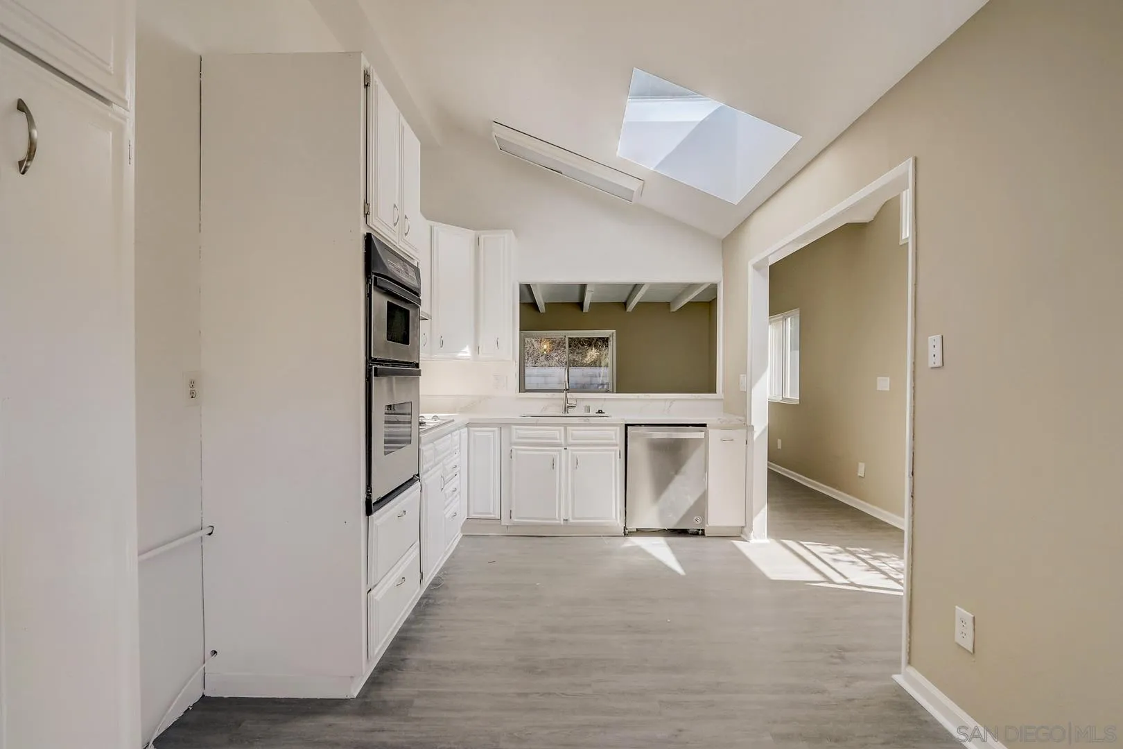 15107 Hesta Street Poway, CA 92064 - Photo 4 of 23 a kitchen with white cabinets and stainless steel appliances