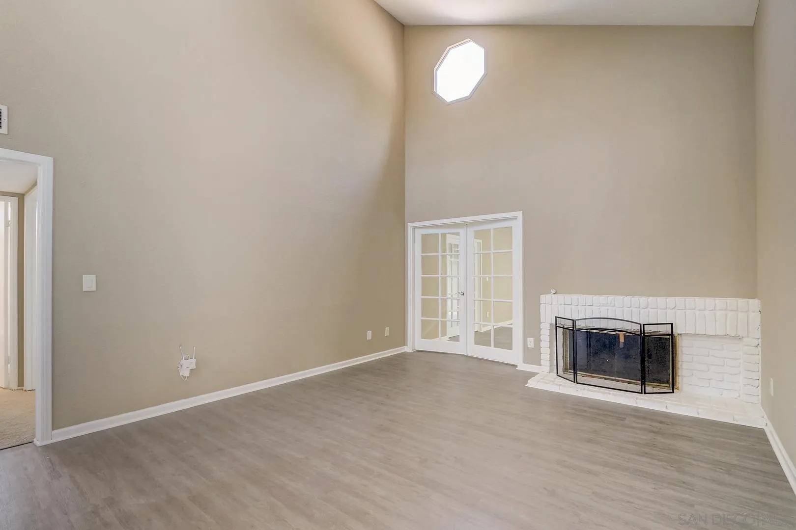 15107 Hesta Street Poway, CA 92064 - Photo 6 of 23 an empty room with a fireplace and windows