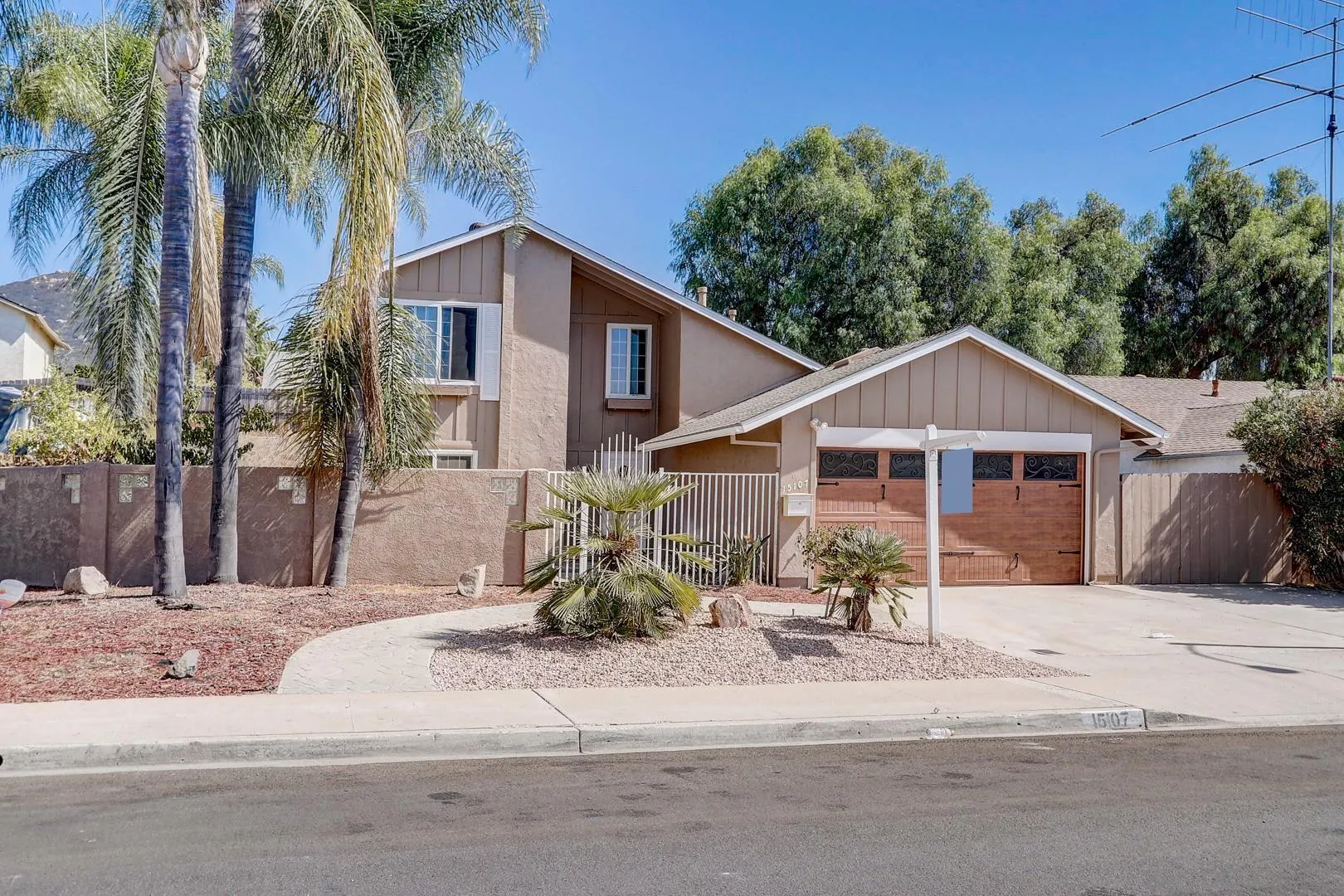 15107 Hesta Street Poway, CA 92064 - Photo 10 of 23 a front view of a house with a yard