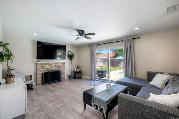 a living room with furniture a fireplace and a flat screen tv