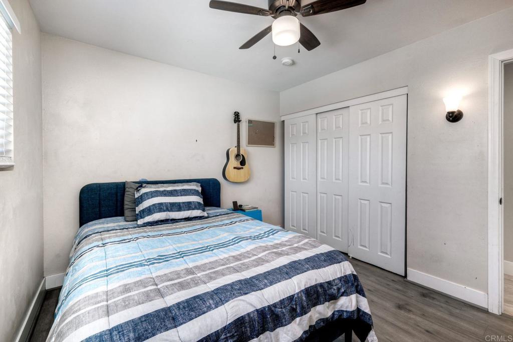 924 Daisy Street Escondido, CA 92027 - Photo 14 of 25 a bedroom with a large bed and wooden floor