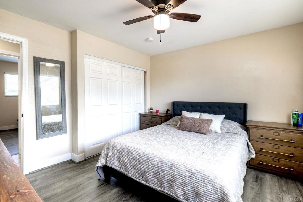 924 Daisy Street Escondido, CA 92027 - Photo 15 of 25 a bedroom with a bed and wooden floor